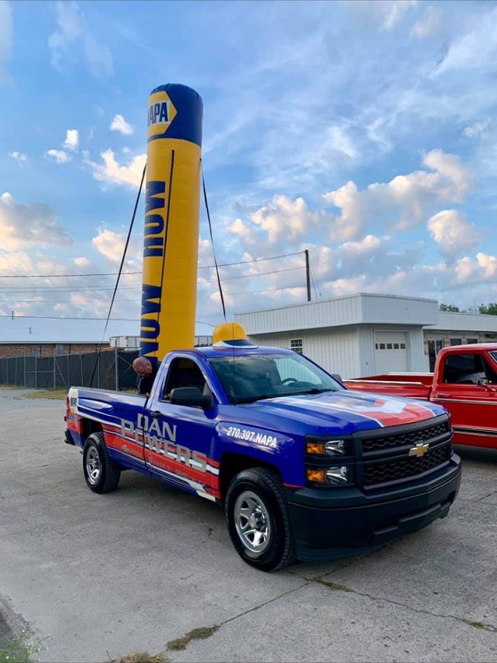 10 ft NAPA branded inflatable tube rising from a pickup truck bed